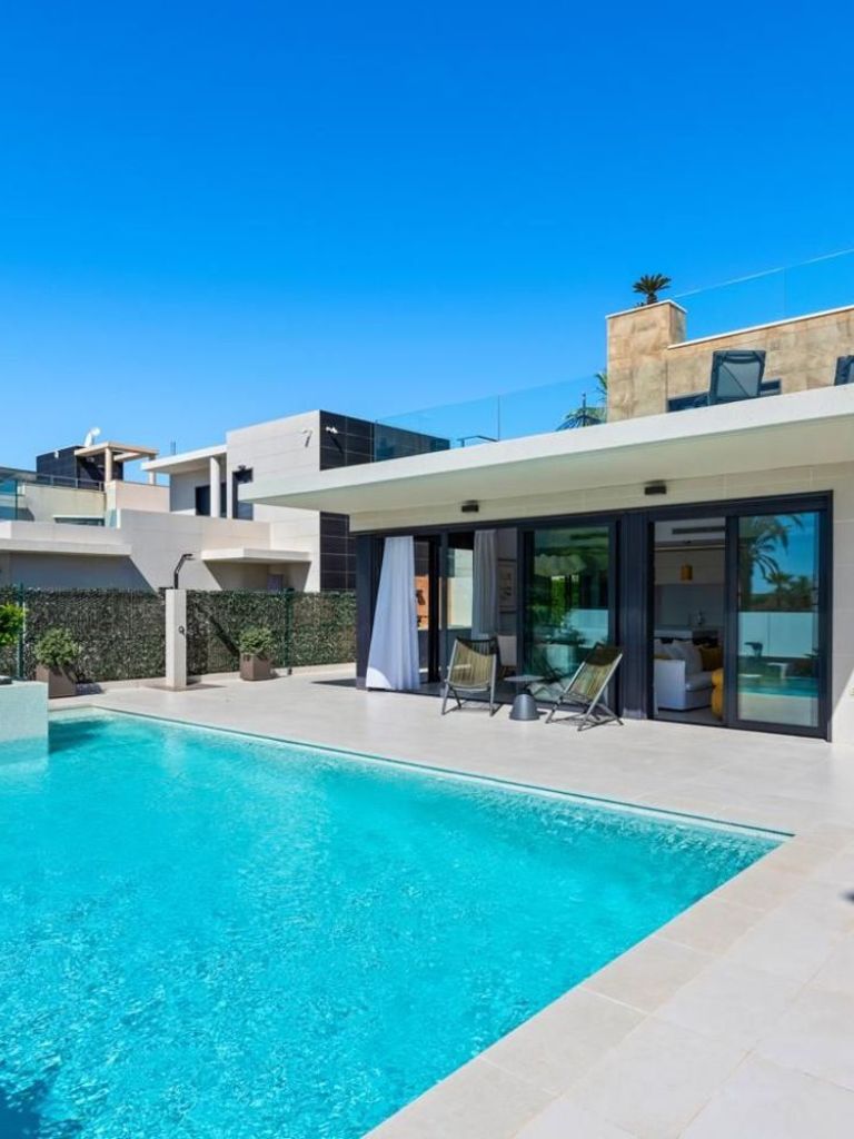 Sold sign in front of Mediterranean-style villa in Spain